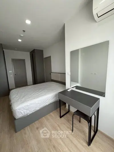 Modern bedroom with sleek furniture and air conditioning in a stylish apartment.