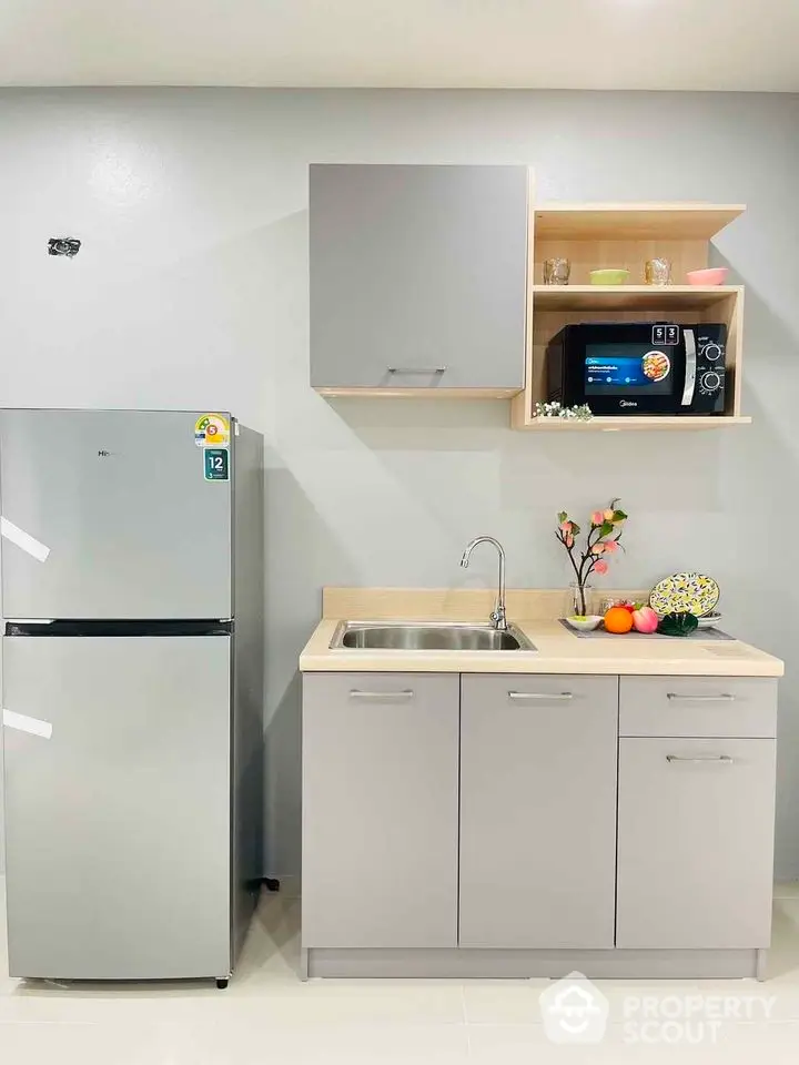 Modern compact kitchen with sleek cabinets and stainless steel appliances