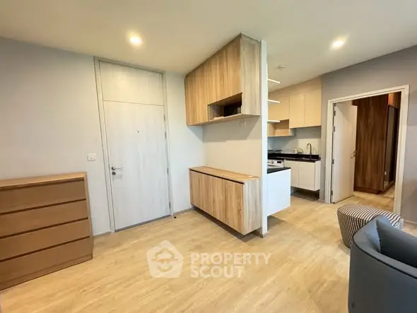 Modern apartment interior with open kitchen and stylish wooden cabinets