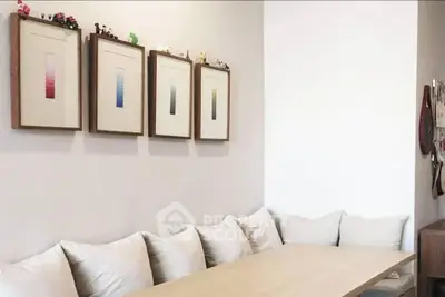 Cozy dining area with minimalist decor and framed art on the wall.