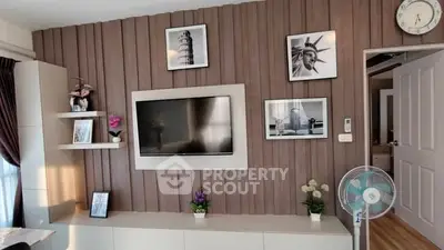 Modern living room with wall-mounted TV and stylish decor