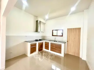 Modern kitchen with sleek cabinetry and gas stove in bright, open layout.