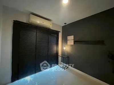 Modern minimalist room with dark blinds and air conditioning