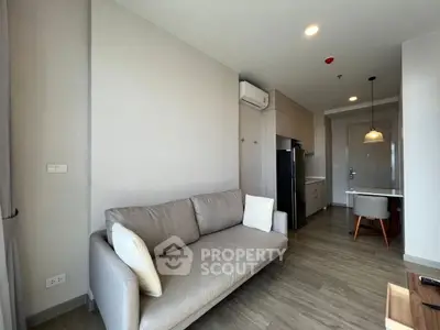 Modern living room with cozy sofa and open kitchen layout