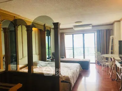 Spacious studio apartment with large windows and cozy furnishings