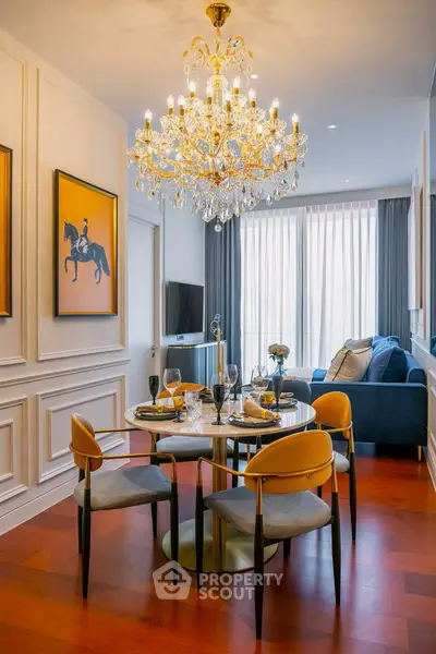 Luxurious living room with elegant chandelier and stylish dining area, perfect for sophisticated urban living.