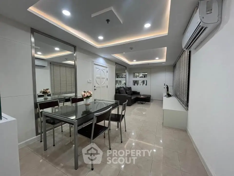 Modern living room with sleek dining area and stylish decor