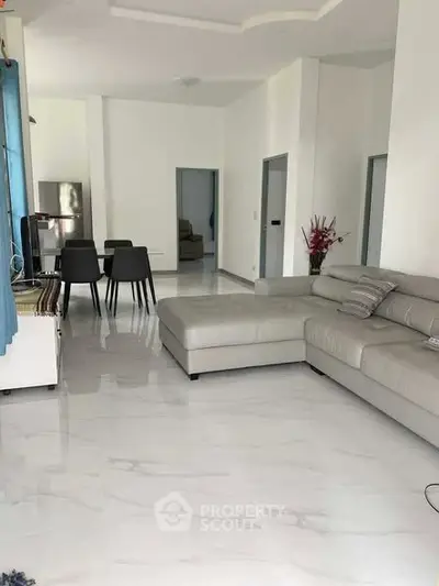 Spacious modern living room with elegant dining area and sleek furniture