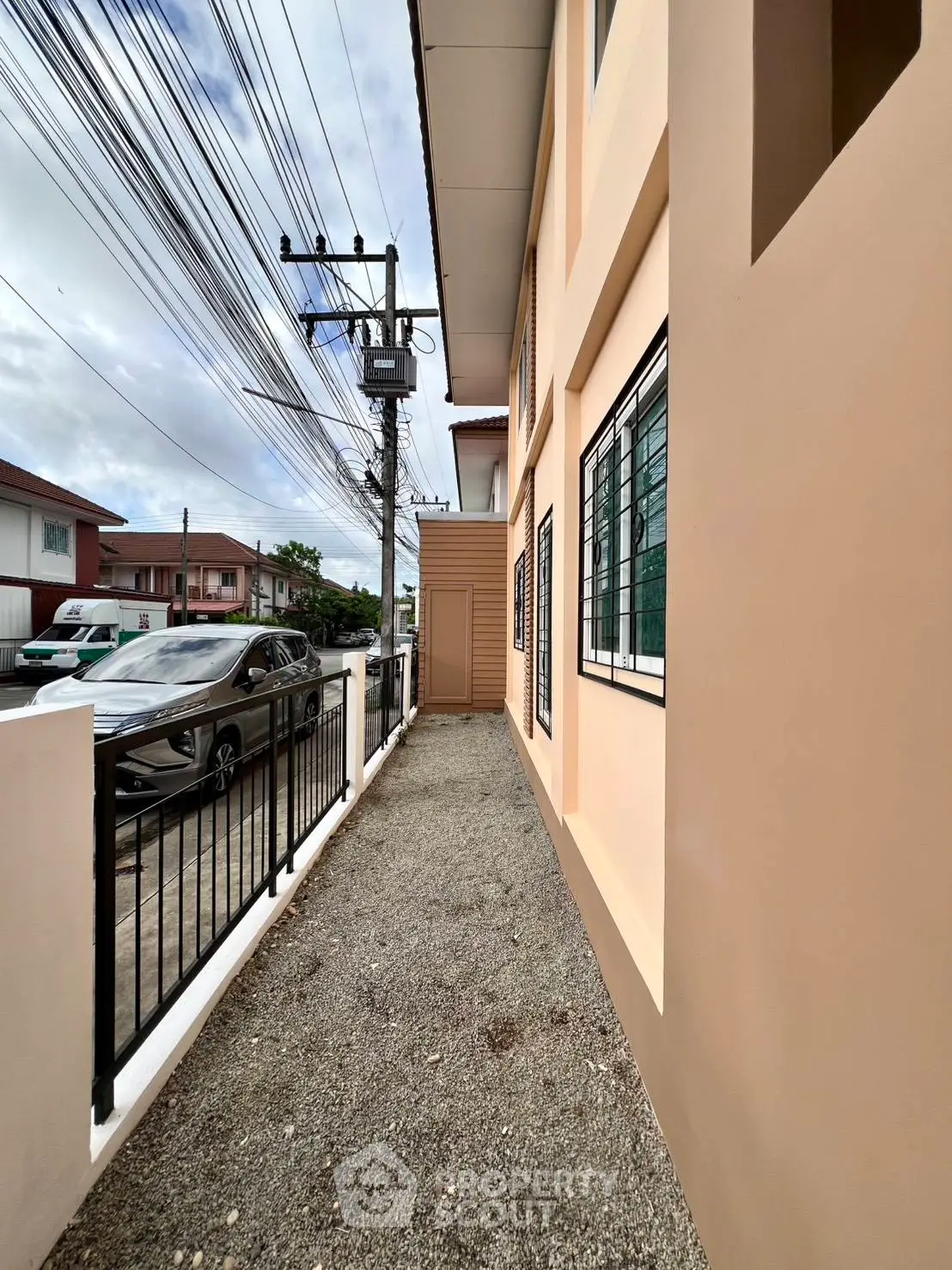 Charming residential exterior with modern design and secure fencing, ideal for urban living.