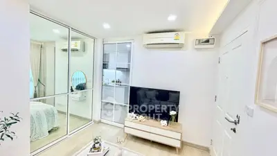 Modern living room with mirrored wall and sleek TV setup in a stylish apartment.