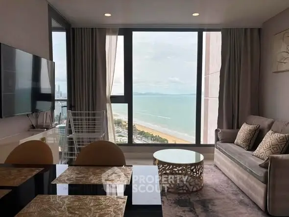 Stunning beachfront living room with panoramic ocean views and modern decor.