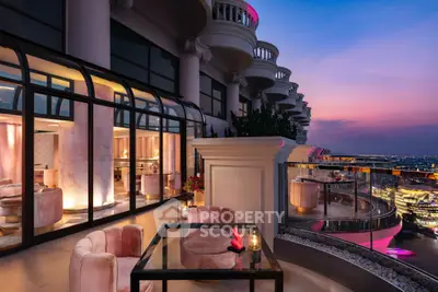 Luxurious balcony with stunning city view at sunset, elegant seating and modern design.