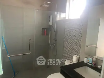 Modern bathroom with glass shower enclosure and sleek fixtures