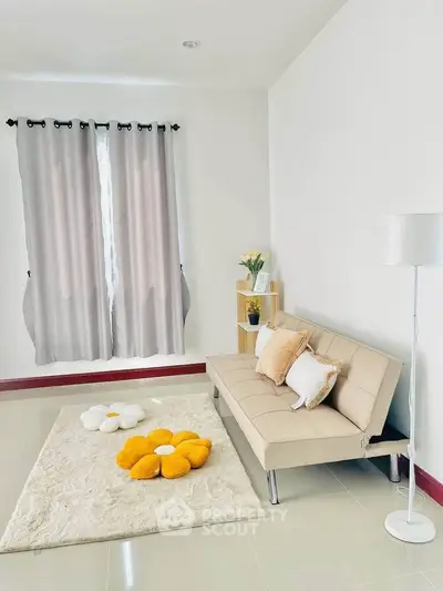 Charming living room with cozy beige sofa and vibrant flower cushions on plush rug.