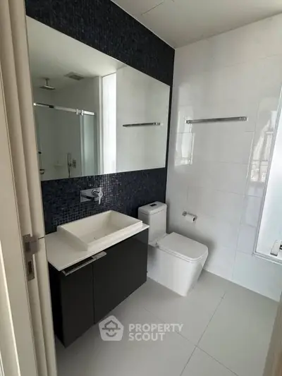 Modern bathroom with sleek fixtures and elegant tile design, perfect for a contemporary home.