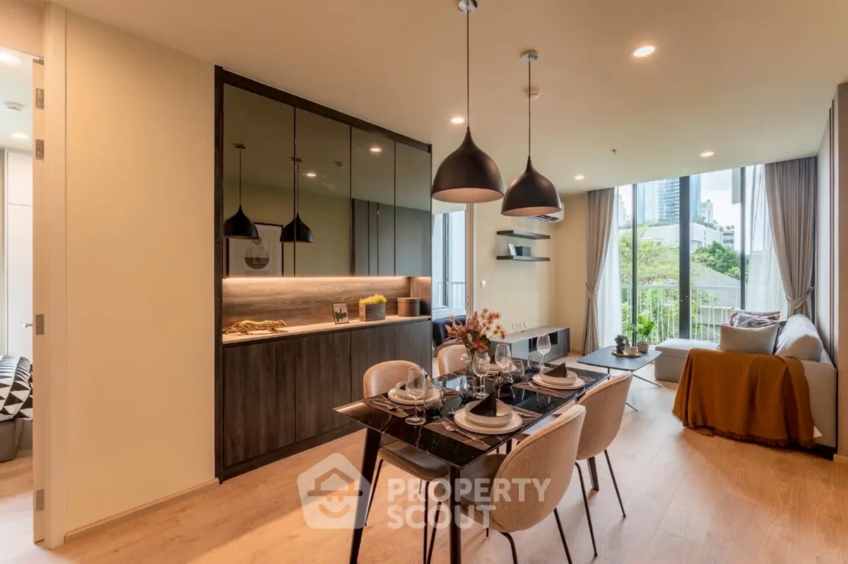 Modern open-plan living room with dining area and city view balcony