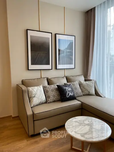 Stylish living room with modern decor, featuring a chic sofa and elegant marble coffee table.
