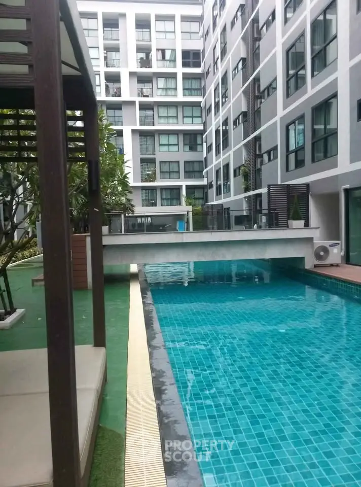 Modern apartment complex with a luxurious outdoor pool and stylish architecture.