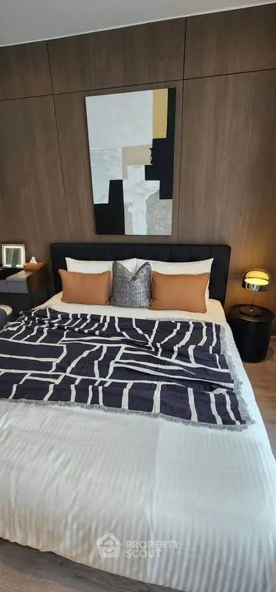 Luxurious bedroom with modern decor and stylish bedding in a contemporary apartment.