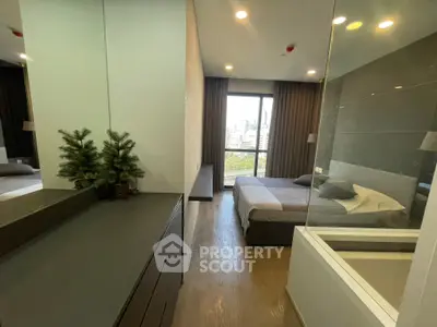 Modern bedroom with city view, sleek design, and cozy ambiance.