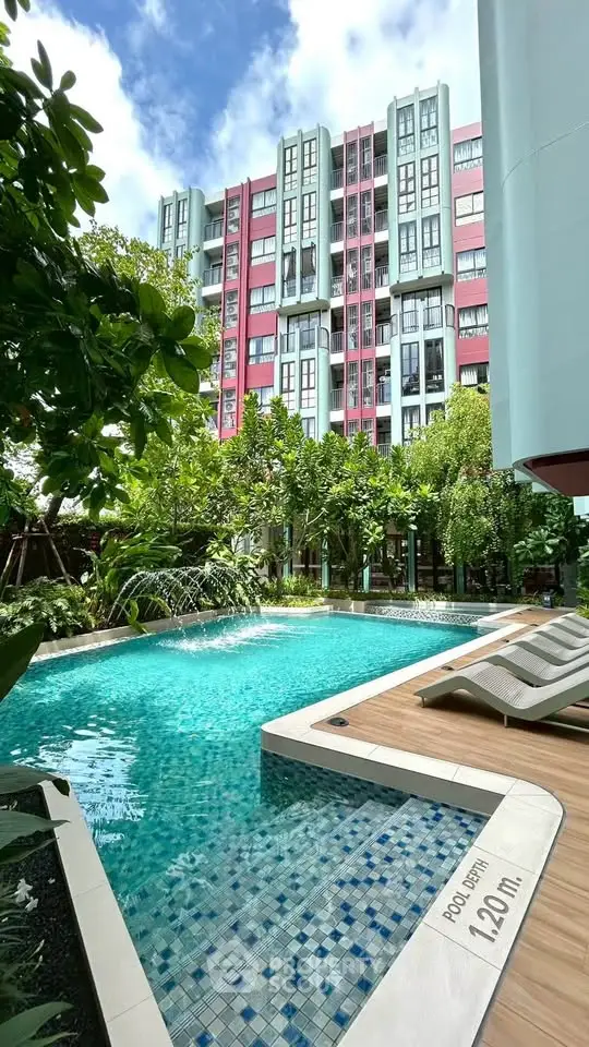 Luxurious apartment complex with stunning pool and lush greenery