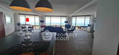 Spacious modern living room with stunning ocean view and open layout.