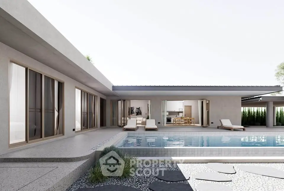 Luxurious modern villa with sleek poolside and elegant outdoor seating area.