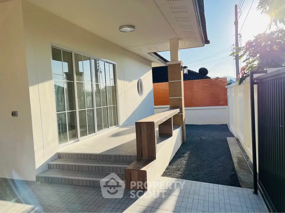 Modern exterior with sleek patio and stylish steps in a sunny setting.