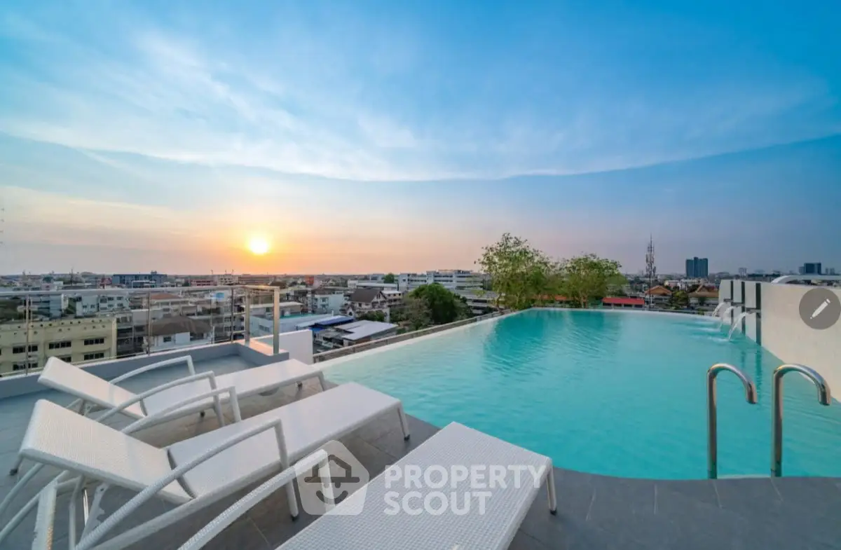 Stunning rooftop pool with panoramic city views at sunset, perfect for relaxation and luxury living.
