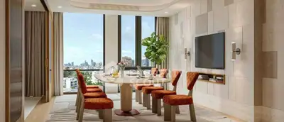 Luxurious dining area with city view, modern decor, and elegant furnishings in a high-rise apartment.