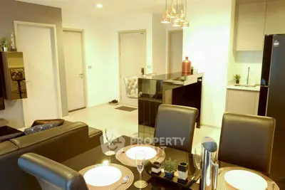 Modern open-plan living and dining area with stylish decor and sleek kitchen appliances.
