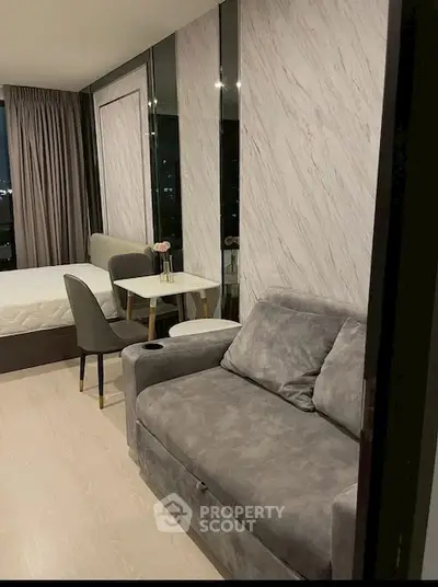 Modern studio apartment with cozy living area and stylish decor