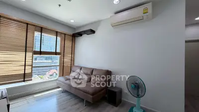 Modern living room with large window, brown sofa, and air conditioning unit.