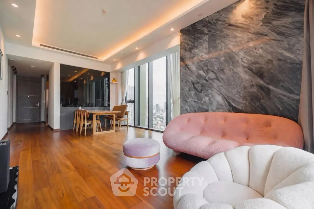 Luxurious modern living room with elegant furniture and city view, featuring stylish decor and open layout.