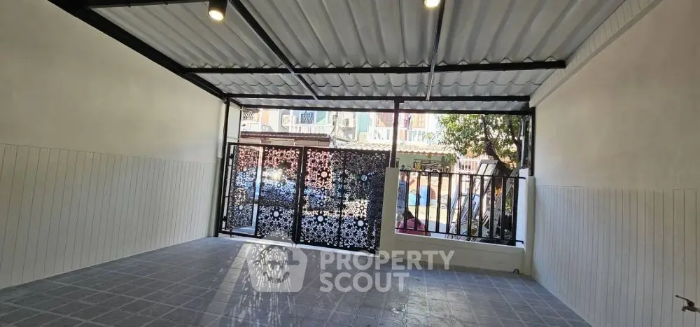 Spacious garage with decorative gate and tiled flooring