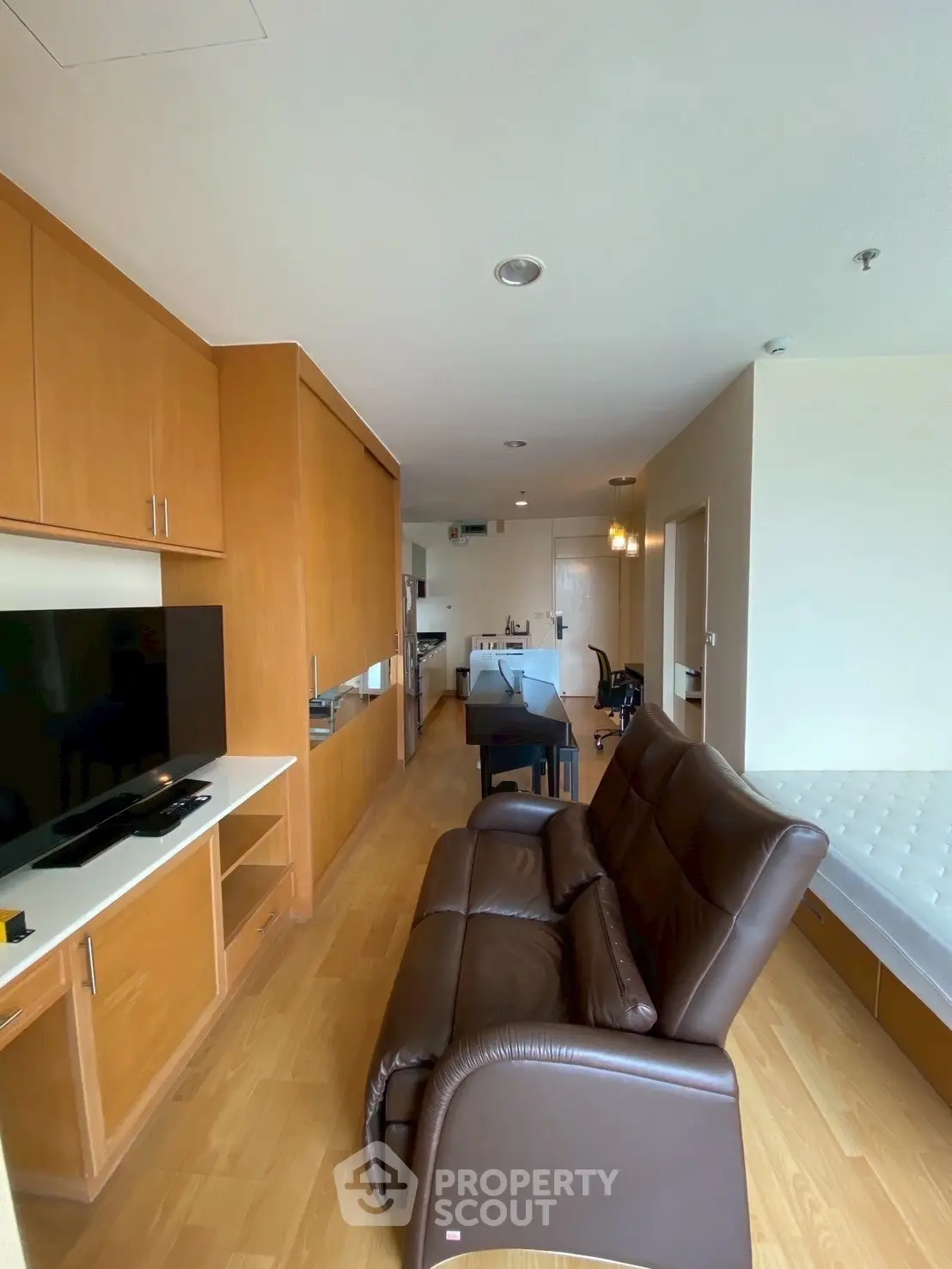 Spacious living room with modern furniture and open kitchen layout in a stylish apartment.