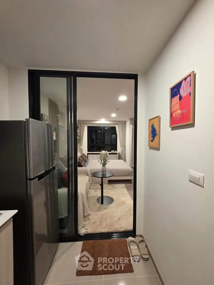 Cozy modern apartment interior with open layout, featuring a stylish kitchen and inviting living area.