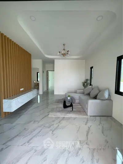 Spacious modern living room with elegant marble flooring and stylish furniture.