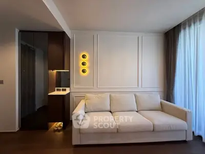 Modern living room with elegant sofa and stylish lighting, featuring floor-to-ceiling curtains and sleek wooden flooring.