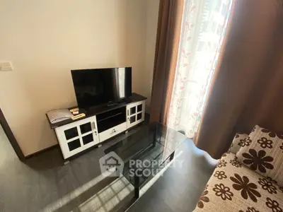 Cozy living room with modern TV setup and floral curtains