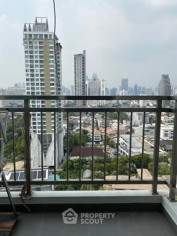 Stunning cityscape view from a high-rise balcony in a modern urban setting.
