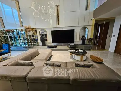 Luxurious modern living room with elegant decor and spacious seating area.