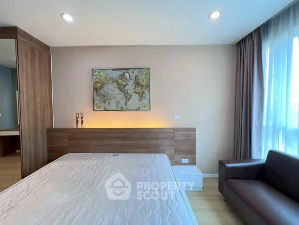 Modern bedroom with world map decor, cozy lighting, and sleek furniture design.