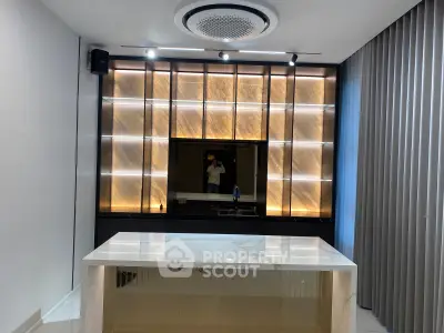 Modern interior with stylish lighting and marble counter in a contemporary living space.