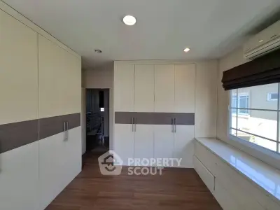 Spacious bedroom with built-in wardrobes and natural light