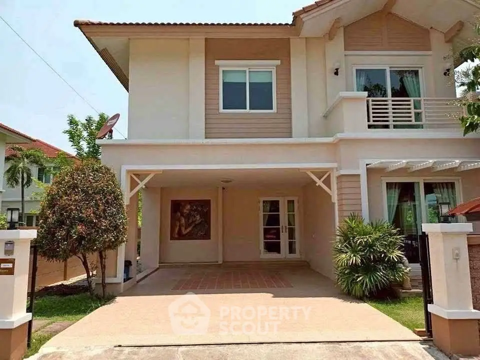 Charming two-story house with spacious driveway and lush greenery, perfect for family living.