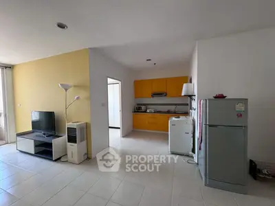 Spacious open-plan living room with modern kitchen and appliances