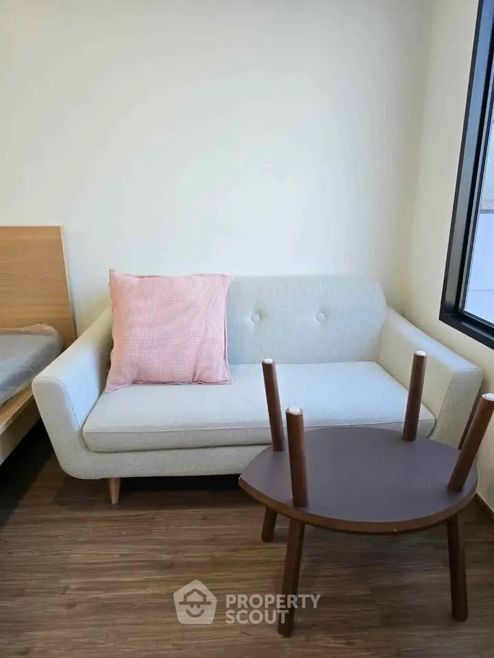 Cozy living room with modern sofa and wooden table, perfect for relaxation.