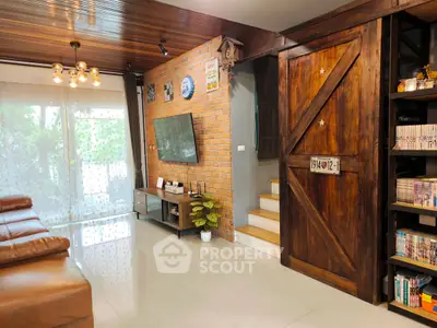 Charming living room with rustic brick wall and wooden accents, featuring cozy leather seating and modern decor.