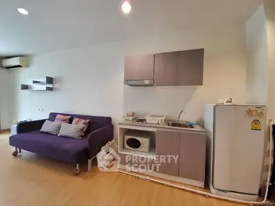 Modern studio apartment with compact kitchen and cozy living area